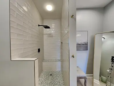 a bathroom with a walk in shower next to a glass door at Village Of South Walton #263A in Rosemary Beach