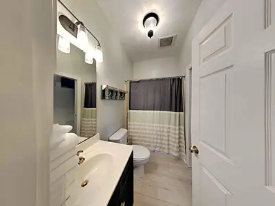 a white bathroom with a sink and a toilet at Village Of South Walton #263A in Rosemary Beach