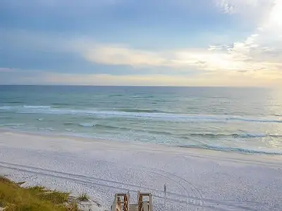 two beach chairs sitting on a beach near the ocean at Sand Piper in Seacrest
