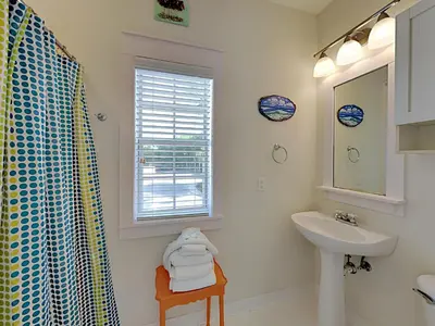 a white bathroom with a sink and a mirror at Bungalows at Seagrove #147 in Seagrove Beach