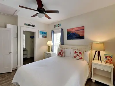 a bedroom with a white bed and a ceiling fan at Bungalows at Seagrove #147 in Seagrove Beach