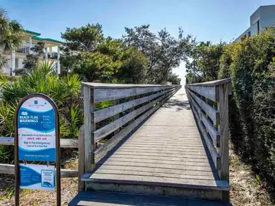 a wooden bridge with a sign in front of it at Bungalows at Seagrove #147 in Seagrove Beach