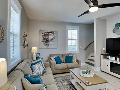 a living room with a couch and a tv at Bungalows at Seagrove #138 in Seagrove Beach