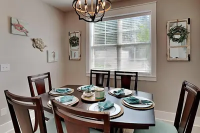 a dining room with a table and chairs and a window at Bungalows at Seagrove #138 in Seagrove Beach