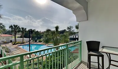 a balcony with a view of a swimming pool at Inn at Seacrest #206 in Rosemary Beach