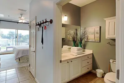 a bathroom with a sink and a toilet and a mirror at Inn at Seacrest #206 in Rosemary Beach