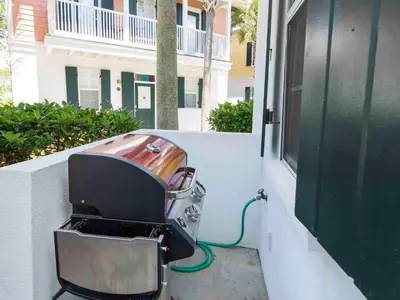 a grill sitting on the side of a building at Bungalows at Seagrove #142 in Seagrove Beach