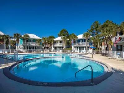 a large swimming pool in front of some houses at Bungalows at Seagrove #142 in Seagrove Beach
