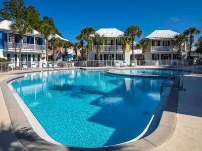a large pool with blue water in a resort at Bungalows at Seagrove #142 in Seagrove Beach