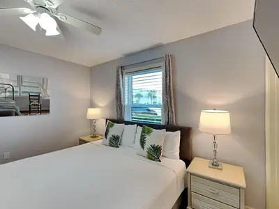 a bedroom with a white bed and a window at Beachside Villas #413 in Seagrove Beach