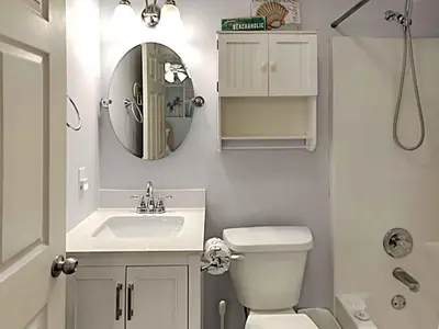 a bathroom with a sink and a toilet and a mirror at Beachside Villas #413 in Seagrove Beach