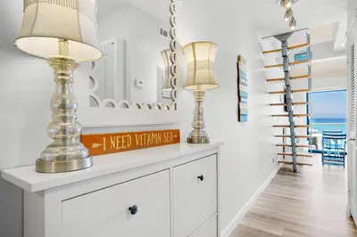 a living room with two lamps on a dresser at Nautical Watch A-11 in Panama City Beach