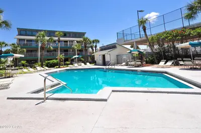 a swimming pool in front of a building at Nautical Watch A-11 in Panama City Beach