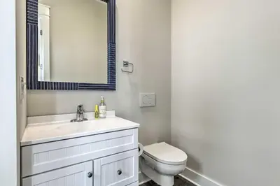 a bathroom with a toilet and a sink and a mirror at Inlet Beach Cottage Close to Beach Access! in Inlet Beach
