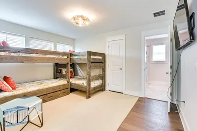 a room with two bunk beds and a tv at Inlet Beach Cottage Close to Beach Access! in Inlet Beach