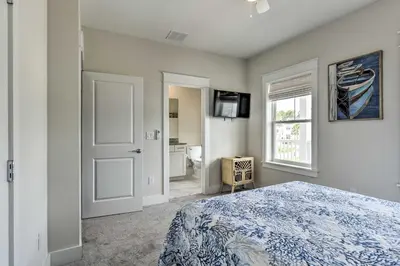 a bedroom with a bed and a window and a television at Inlet Beach Cottage Close to Beach Access! in Inlet Beach