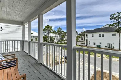 a balcony with a bench and a view of the street at Inlet Beach Cottage Close to Beach Access! in Inlet Beach
