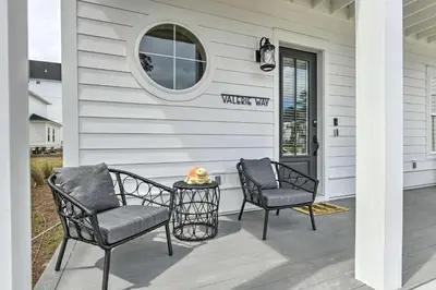 two chairs and a table on a front porch at Inlet Beach Cottage Close to Beach Access! in Inlet Beach