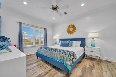 a bedroom with a blue bed and a window at Legacy 506- The Coastal Gem in Santa Rosa Beach