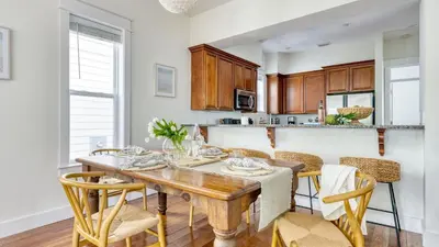 a dining room with a wooden table and chairs at Chic 30A Beach Home Views Ping Pong 5-Min Walk to Carillon Beach Bellview in Sunnyside