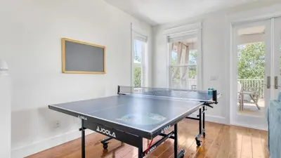 a ping pong table in a living room with a table at Chic 30A Beach Home Views Ping Pong 5-Min Walk to Carillon Beach Bellview in Sunnyside