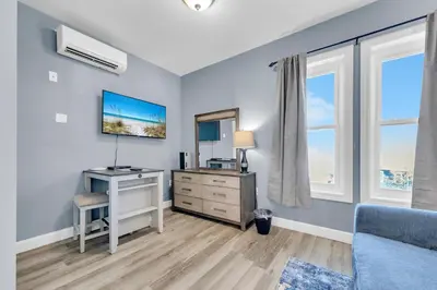 a bedroom with a desk and a dresser with a mirror at Village of South Walton B377-G in Rosemary Beach