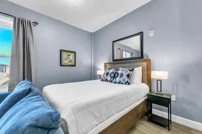 a bedroom with a bed and a mirror on the wall at Village of South Walton B377-G in Rosemary Beach