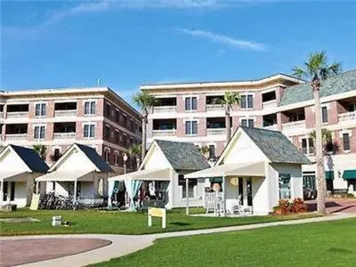 a group of houses in front of a large building at Village of South Walton B377-G in Rosemary Beach