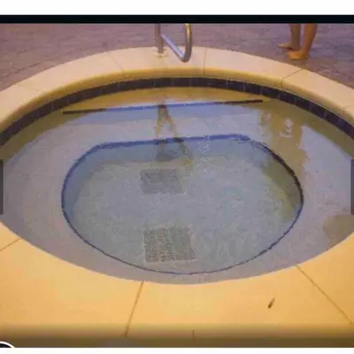 a pool of water with a person standing in it at Celadon Beach Resort in Panama City Beach