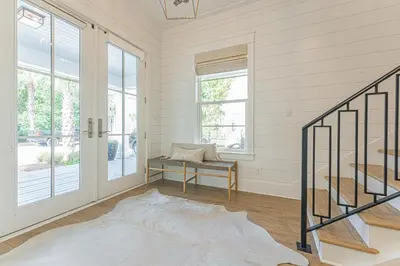 a living room with a staircase and a window at The Crown Jewel of Seacrest Beach in Inlet Beach