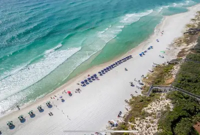 an overhead view of a beach with umbrellas and the ocean at The Crown Jewel of Seacrest Beach in Inlet Beach