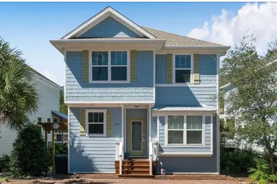 a blue and white house with a porch at Beautiful 4 bedroom near Rosemary Beach! in Inlet Beach