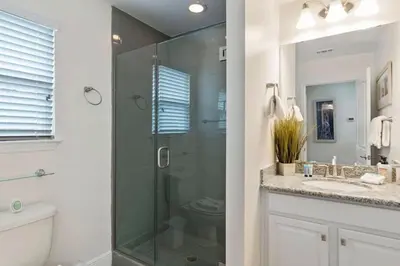 a bathroom with a glass shower and a toilet at Beautiful 4 bedroom near Rosemary Beach! in Inlet Beach