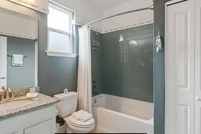 a bathroom with a tub and a toilet and a sink at Beautiful 4 bedroom near Rosemary Beach! in Inlet Beach
