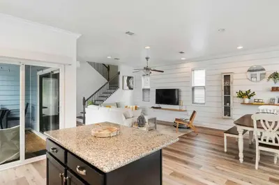 a kitchen and living room with a counter and a table at Beautiful 4 bedroom near Rosemary Beach! in Inlet Beach