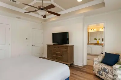 a bedroom with a bed and a flat screen tv at Beautiful 4 bedroom near Rosemary Beach! in Inlet Beach