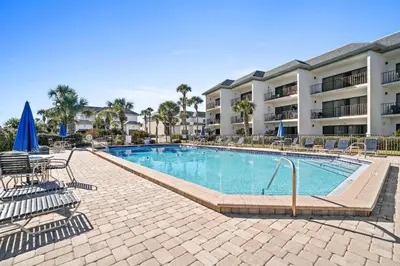 a swimming pool with chairs and a hotel at 30A Emerald Hill Beach Resort by Panhandle Getaways in Santa Rosa Beach