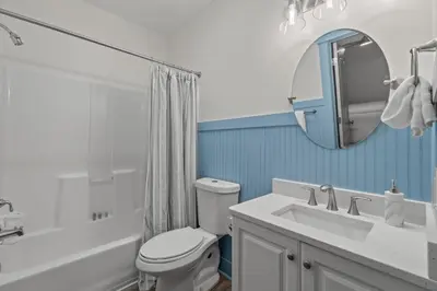 a bathroom with a toilet and a sink and a mirror at 30A Villas at Seagrove by Panhandle Getaways in Santa Rosa Beach