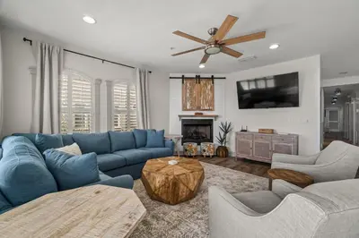 a living room with blue couches and a tv at 30A Villas at Seagrove by Panhandle Getaways in Santa Rosa Beach