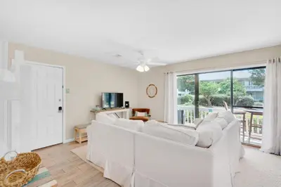 a living room with white furniture and a large window at Beachwood Villas 1A- Beach Haven in Santa Rosa Beach