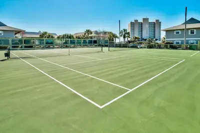 a tennis court with two tennis rackets on it at Beachwood Villas 1A- Beach Haven in Santa Rosa Beach
