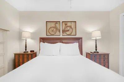 a bedroom with a large white bed with two lamps at Beachwood Villas 1A- Beach Haven in Santa Rosa Beach