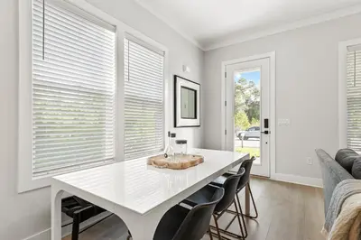 a white dining room with a white table and chairs at 30A Beach House - Casa Brisa in Inlet Beach