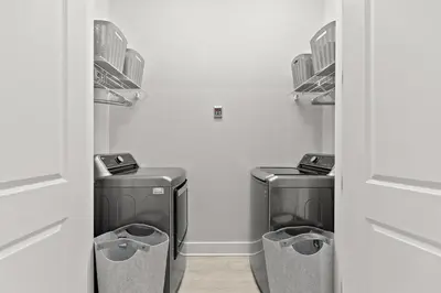 two washing machines in a laundry room with a wall at 30A Beach House - Casa Brisa in Inlet Beach