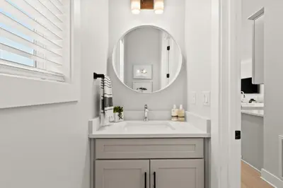 a white bathroom with a sink and a mirror at 30A Beach House - Casa Brisa in Inlet Beach