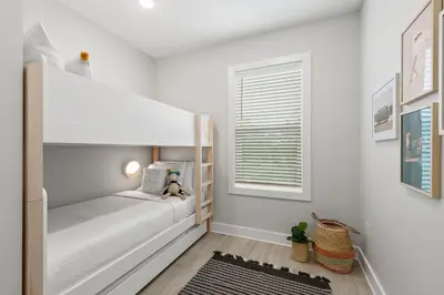 a white bedroom with a bunk bed and a window at 30A Beach House - Casa Brisa in Inlet Beach