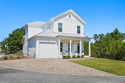 a white house with a driveway at 30A Beach House - Casa Brisa in Inlet Beach