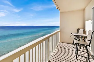a balcony with two chairs and a view of the ocean at Celadon 1103 - Beach Paradise in Panama City Beach