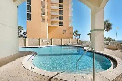 a swimming pool in front of a building at Celadon 1103 - Beach Paradise in Panama City Beach