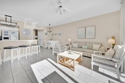 a living room with a couch and a table at Celadon 1103 - Beach Paradise in Panama City Beach